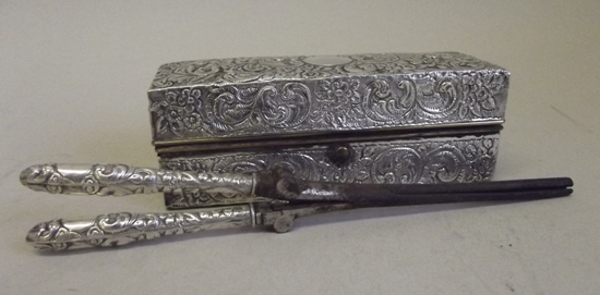 Kristin Holt | Victorian Curling Irons. Photograph of a late Victorian, embossed, silver mounted curling iron with heater and box, with maker's mark of Charles Fox & Co. Ltd and Chester hallmark for 1897. Sold by The Salesroom in 2013.